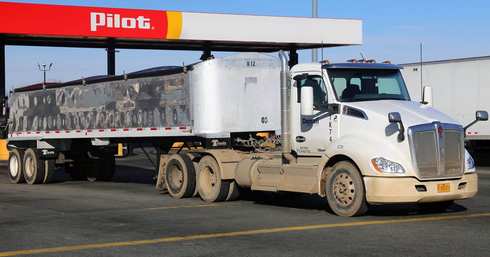 Kenworth tractor with dump trailer at a truck stop