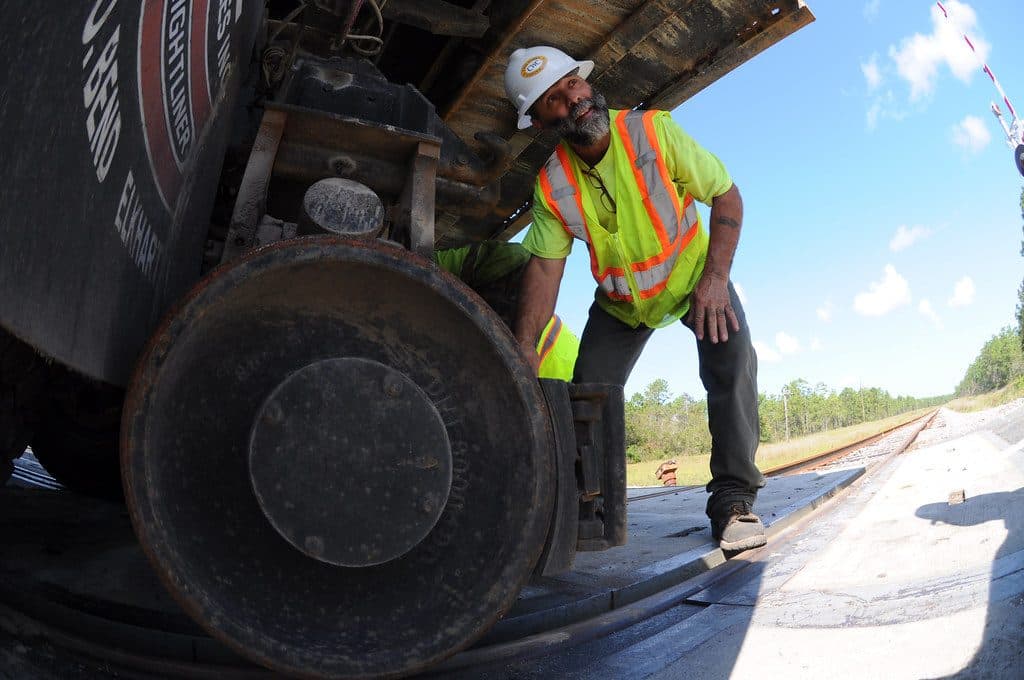 Worker inspecting a heavy truck wheel-end