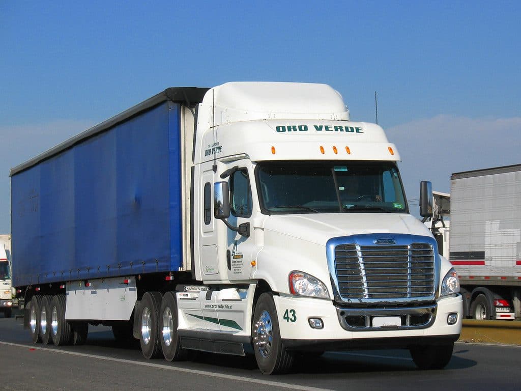White tractor with curtain-side trailer